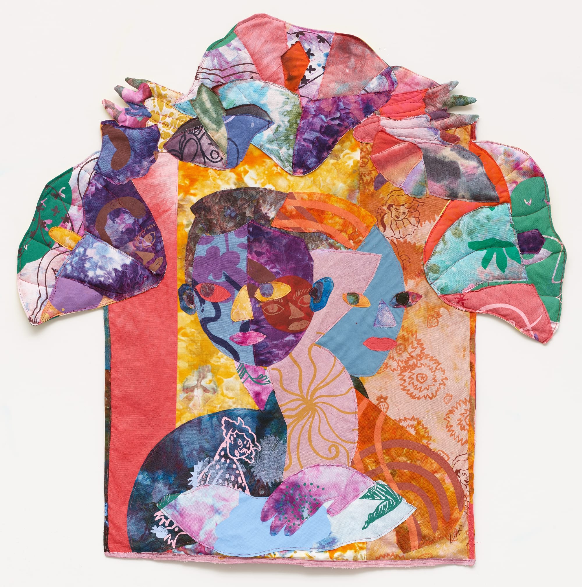 a textile portrait of a woman in vivid, patterned fabrics