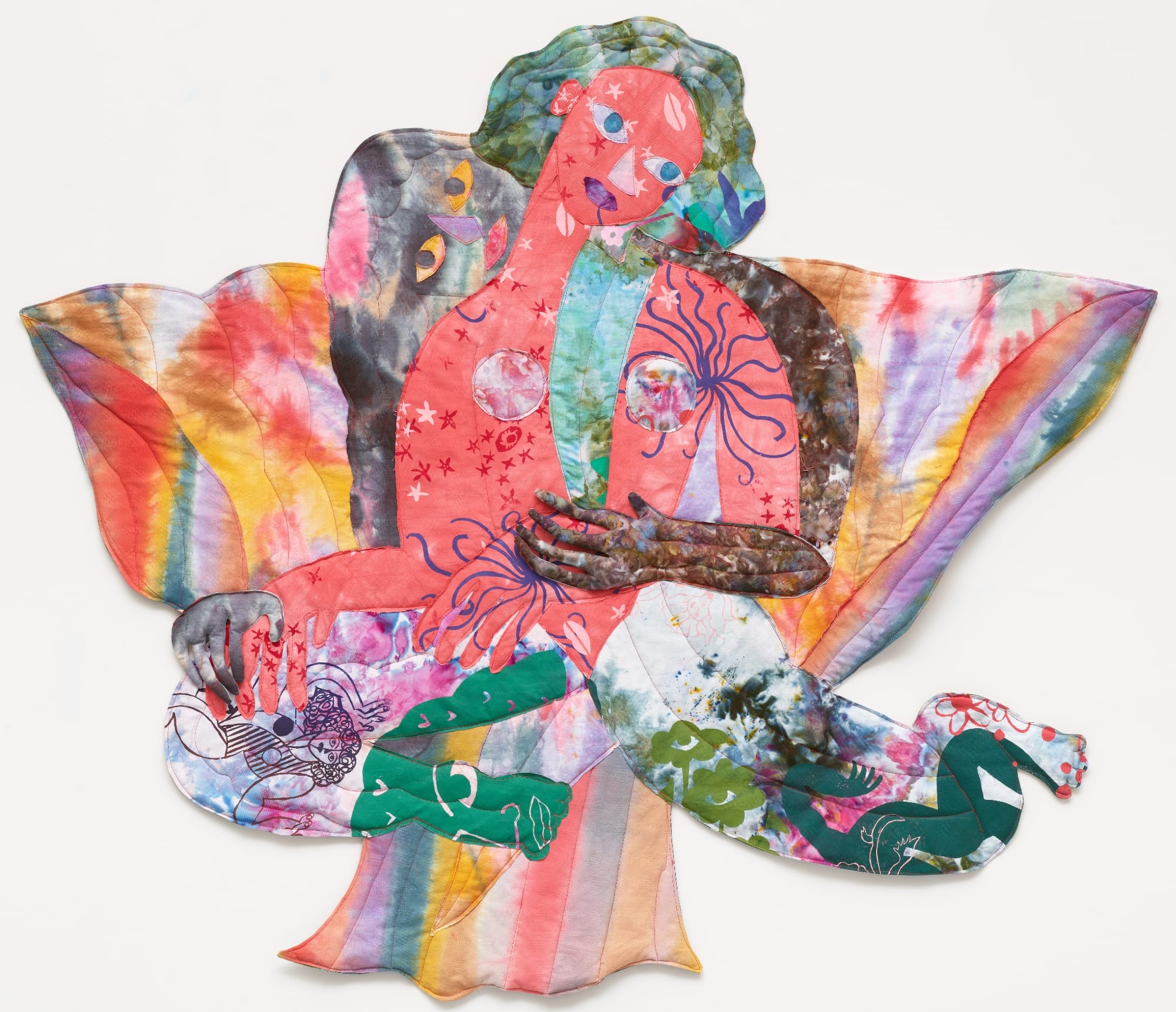 a textile portrait of a woman in vivid, patterned fabrics