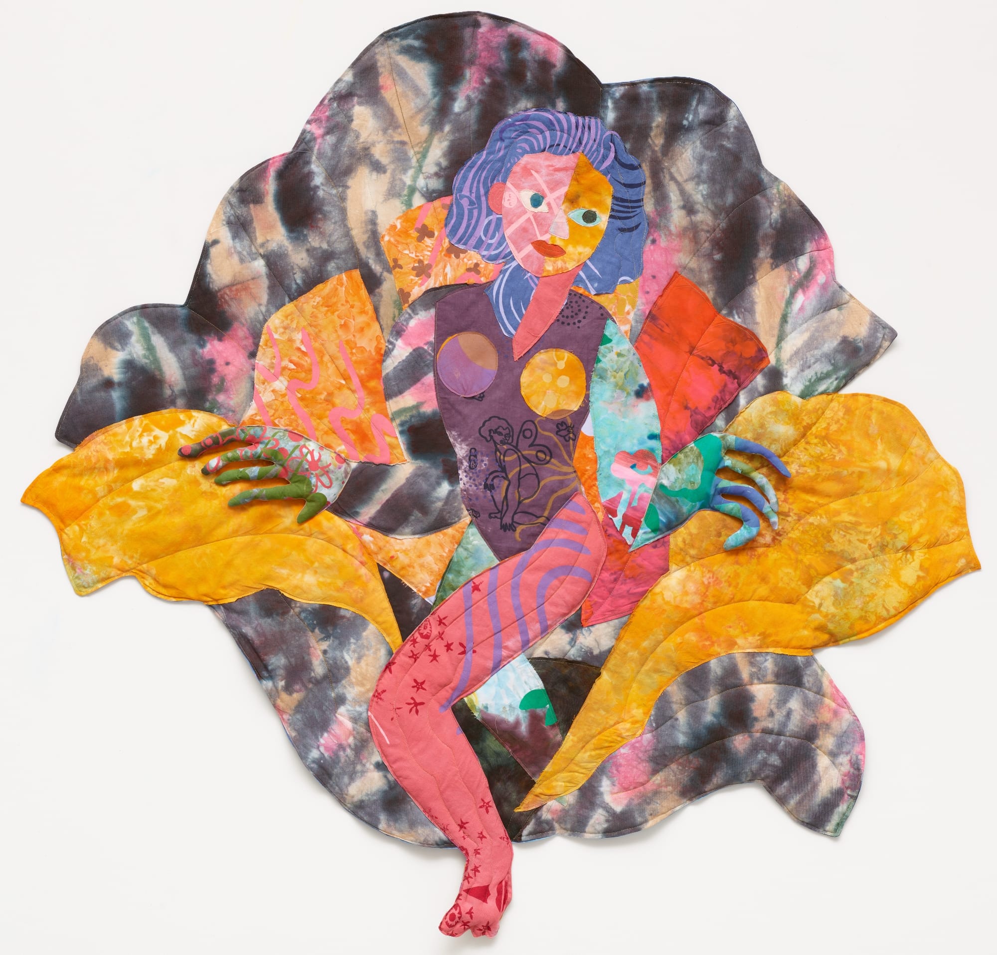 a textile portrait of a woman in vivid, patterned fabrics