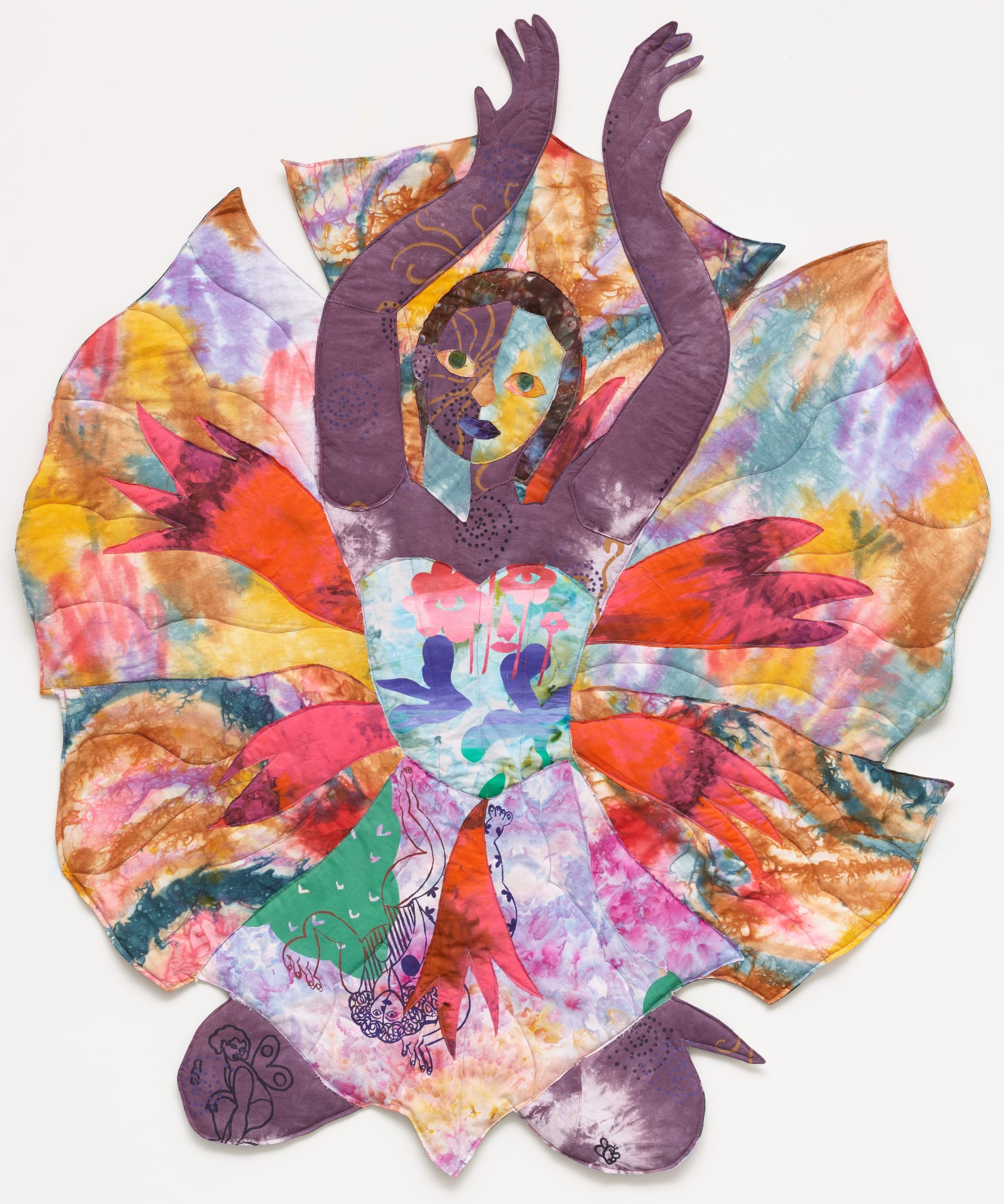 a textile portrait of a woman in vivid, patterned fabrics