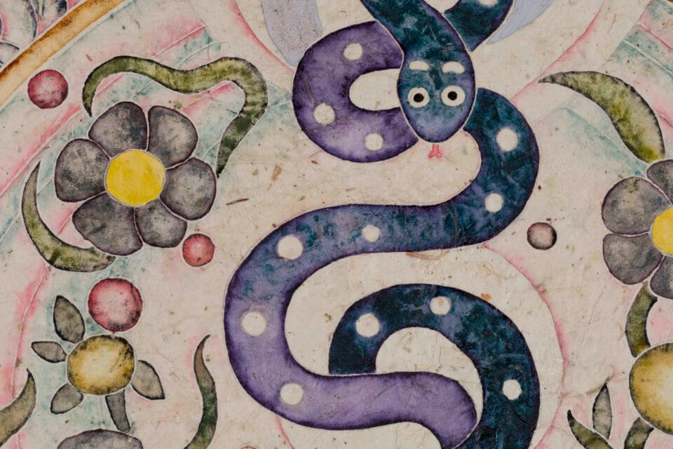 detail of a natural pigment painting by Omar Mendoza, featuring cosmic symbols and visual motifs evoking Mesoamerican ancestry