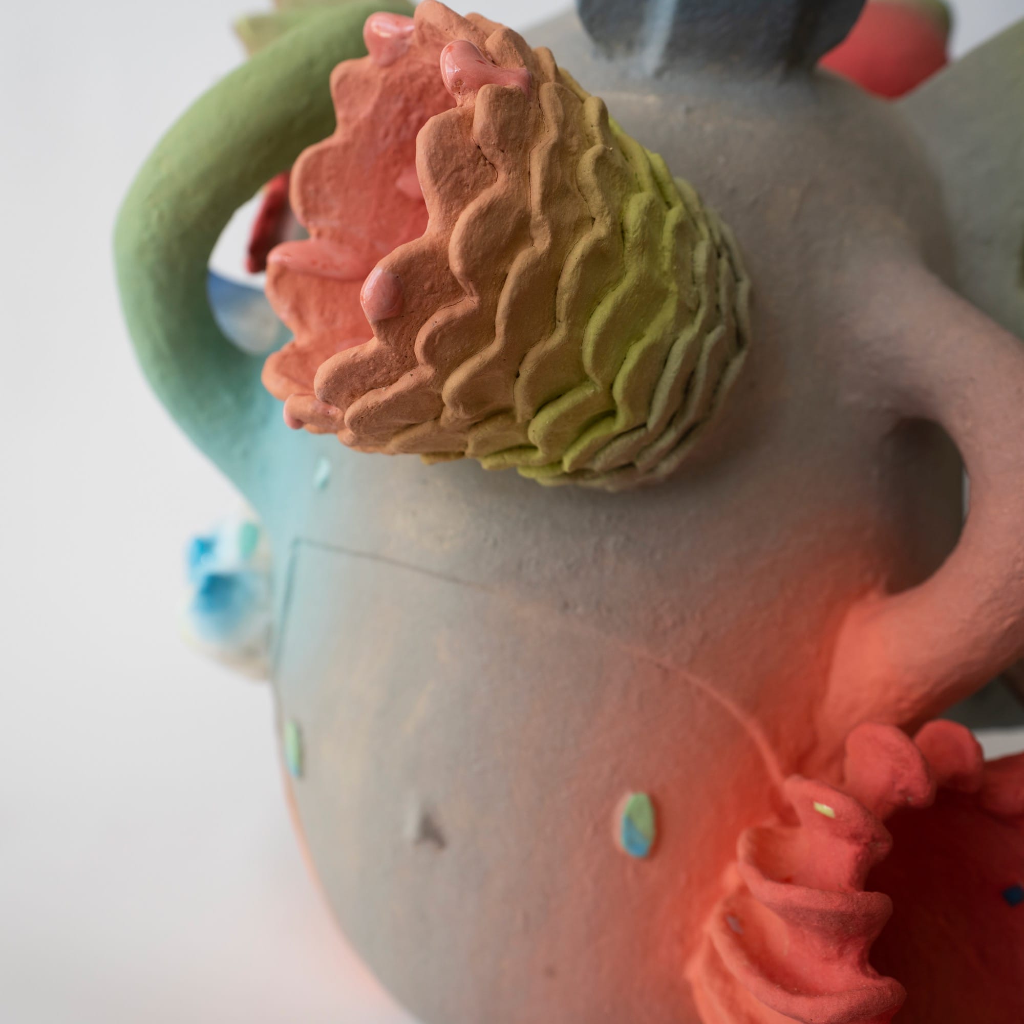 detail of a ceramic head sculpture by Janny Baek with various floral forms emerging 