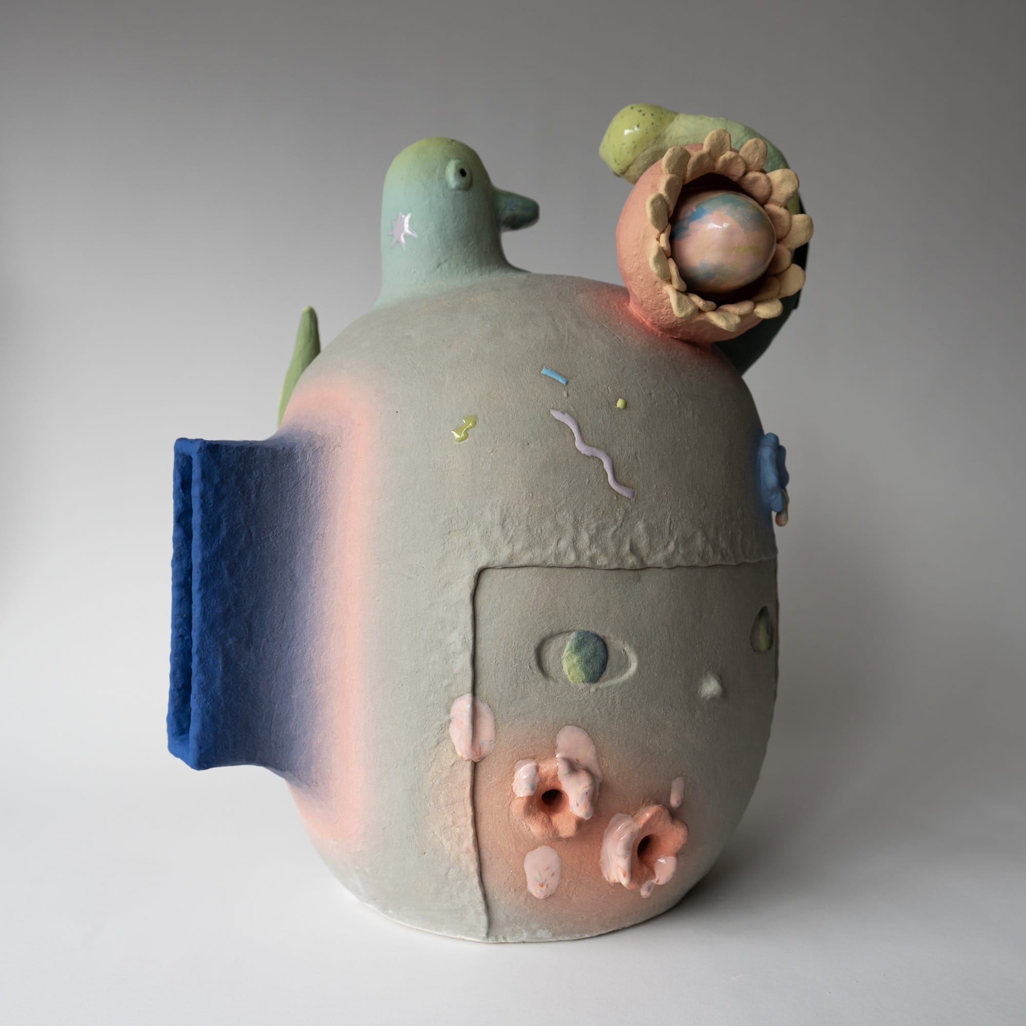 a ceramic head sculpture by Janny Baek with various floral forms emerging