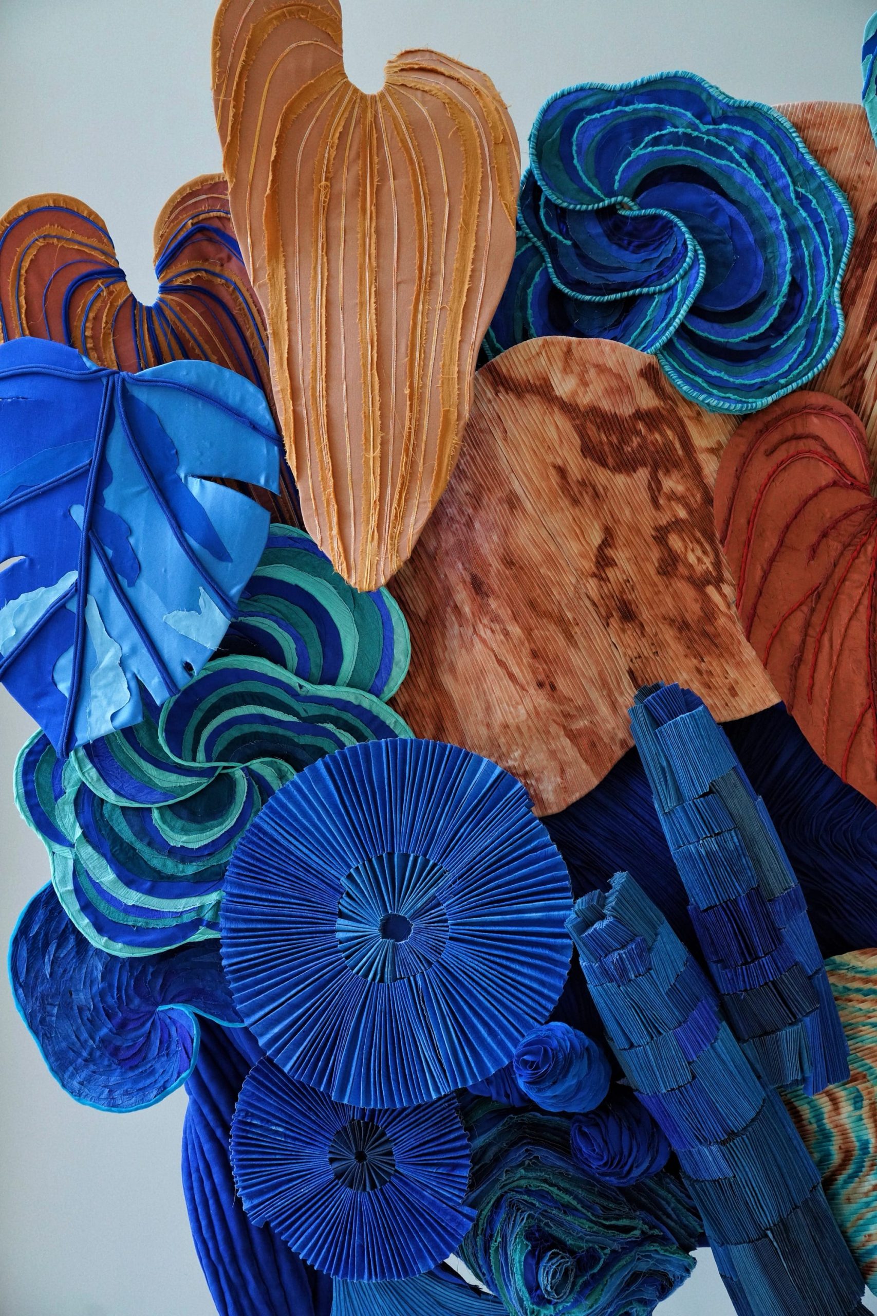 the detail of a blue and orange botanical installation